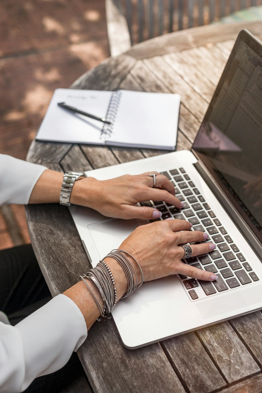 person-typing-on-macbook-pro-on-brown-wooden-table-during-daytime-photo-0qvtyp0gh3a